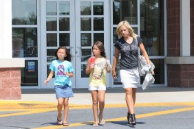 Kate Gosselin, black t shirt, black strappy heels, white mini skirt, silver bag